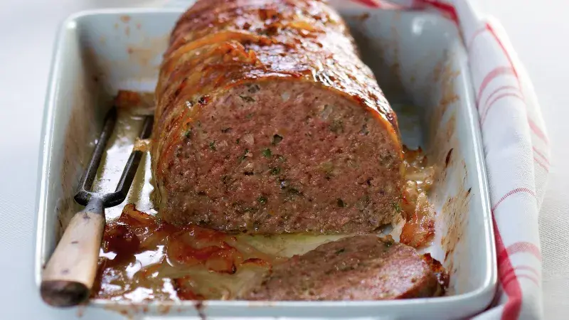 Sliced meatloaf in baking dish