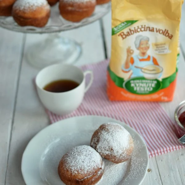 Homemade yeast donuts with powdered sugar and tea