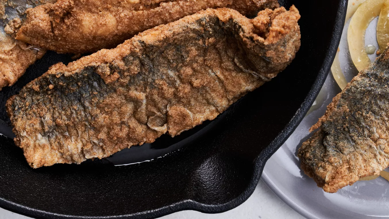 Fried fish fillets in skillet