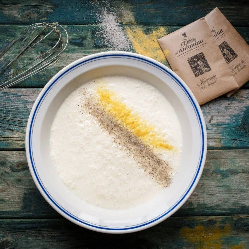 Bowl with ingredients for cheesecake batter
