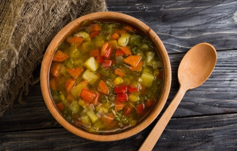 Vegetable soup in wooden bowl