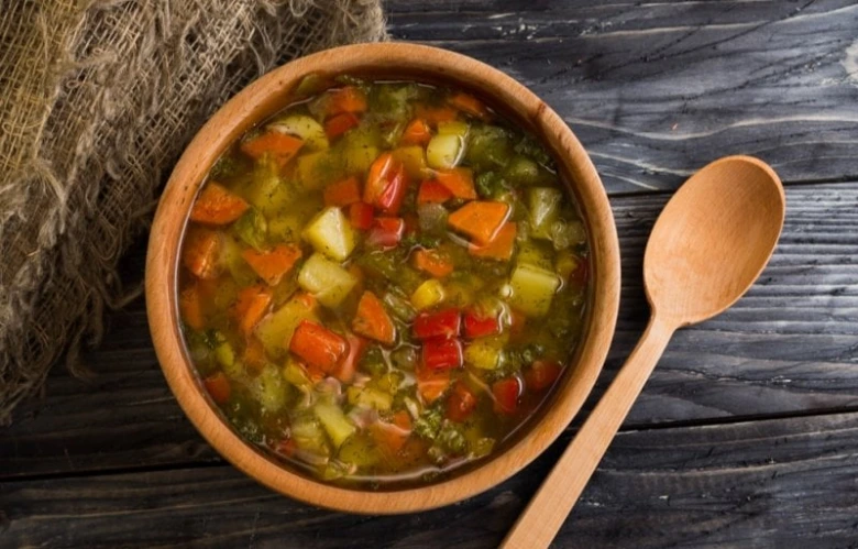 Vegetable soup in wooden bowl